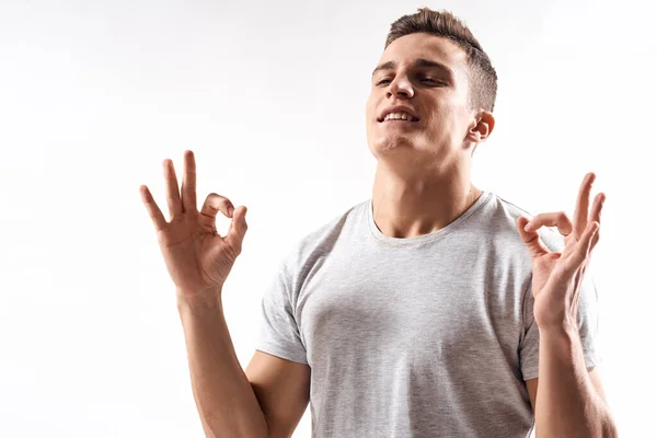 Sporty man in white t-shirt on a light background gesturing with his hands cropped view Copy Space — Stock Photo, Image