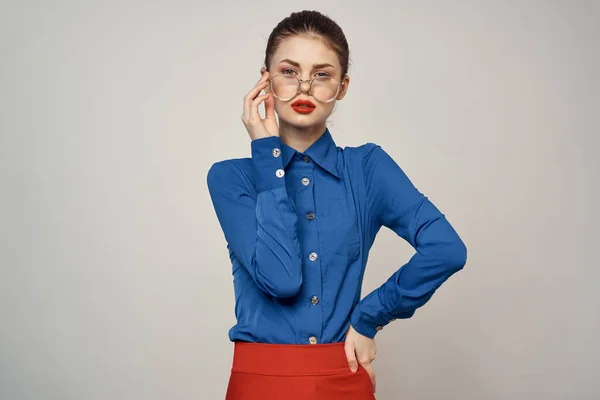 Woman model in blue shirt and red skirt glasses beautiful face makeup studio — Stock Photo, Image