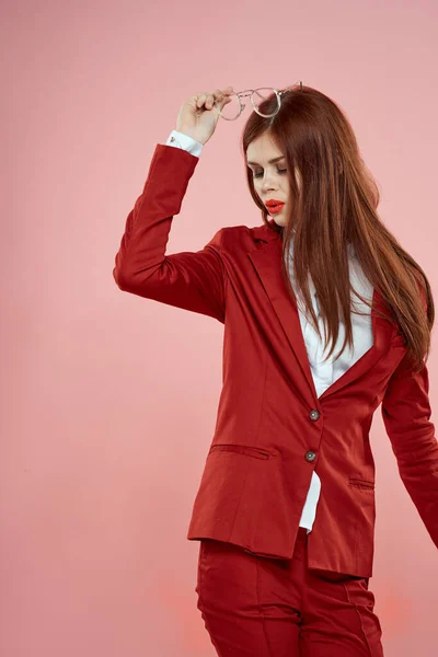 Mulher elegante em blazer vermelho óculos segurando lábios vermelhos fundo rosa — Fotografia de Stock