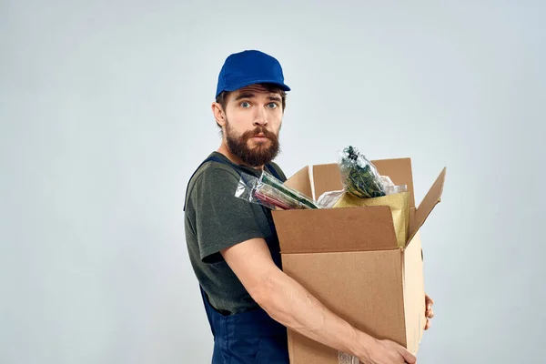Male worker loading delivery boxes in hands packing lifestyle
