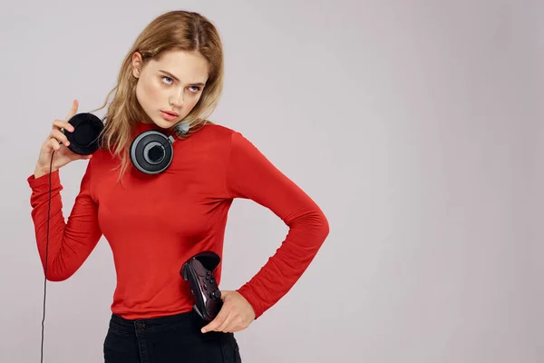 Femme avec contrôleur casque dans les mains un jeu de console amusant loisirs veste rouge style de vie arrière-plan léger — Photo