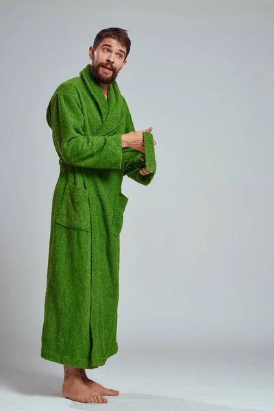 Emotional man in a green robe on a light background in full growth fun emotions model — Stock Photo, Image