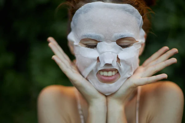 Portrait of a woman face mask Closed eyes and show teeth bare shoulders — Stock Photo, Image