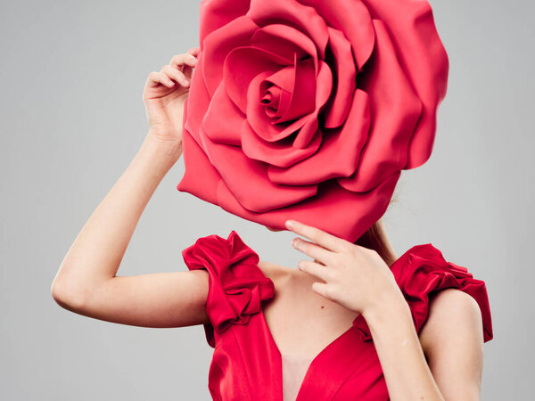 Decorative flower in the face of a woman in a red dress 