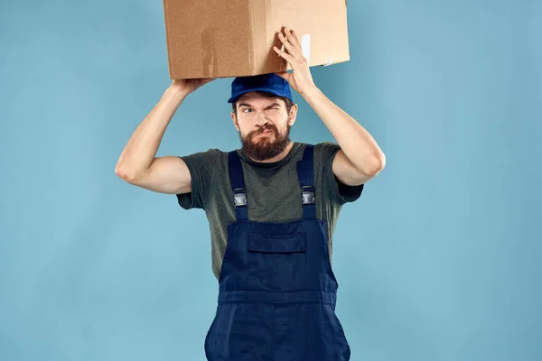 working man boxes in hands delivery service packaging lifestyle blue background