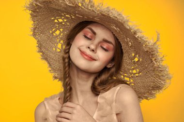 Şapkalı ve elbiseli bir bayan. Kızıl saçlı, sarı arka planlı, model portresi eğlenceli.