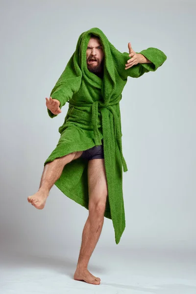 Emotional man in a green robe on a light background in full growth fun emotions model — Stock Photo, Image