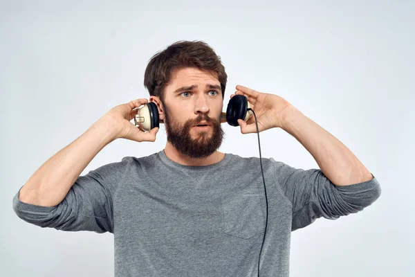 Man met koptelefoon muziek lifestyle emoties technologie moderne stijl ontspanning licht achtergrond — Stockfoto