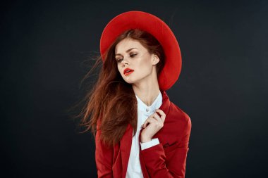 Kırmızı şapkalı zarif kadın ceketi, göz kamaştırıcı yaşam tarzı koyu renk arka plan.