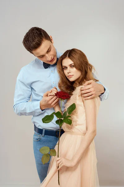 Mladý pár objetí romantiku datování životní styl vztah světlo pozadí červená růže — Stock fotografie