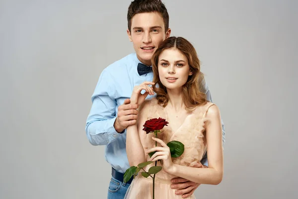 Fröhlich junges Paar Romantik Umarmung Beziehung rote Rose Lifestyle Licht Hintergrund — Stockfoto