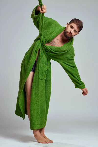 Emotional man in a green robe on a light background in full growth fun emotions model — Stock Photo, Image