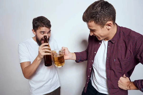 Two friends drink beer leisure fun alcohol friendship lifestyle light background — Stock Photo, Image