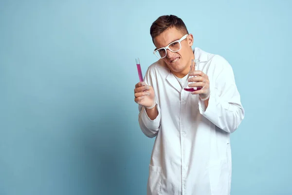 Elinde renkli sıvı kimya laboratuvarı modeli olan gözlüklü bir adam var. — Stok fotoğraf