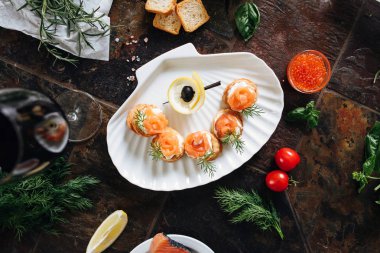 Somon ile puf pasta meze, Philadelphia peynir ve beyaz deniz kabuğu plaka üzerinde dereotu kırmızı şarap ile servis.