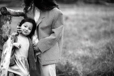 Ormanın yakınındaki bir yaya köprüsünde kızıyla birlikte anne portresi.