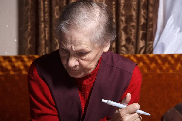 Old women with pen — Stock Photo, Image