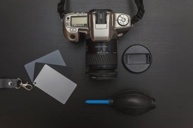 çalışma alanı fotoğrafçı fotoğrafçılık dijital SLR kamera sistemi, kamera Temizleme Kiti ile üstten görünüm üzerinde siyah tablo arka planı