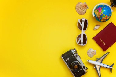 Düz Lay çınar, bağbozumu kamera, pasaport, dünya, güneş gözlüğü ve kabuk üzerinde sarı renkli şık modern moda arka plan ile. Tatil seyahat yaz hafta sonu deniz macera seyahat kavramı