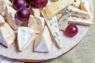 Peynir farklı tipleri ile Yönetim Kurulu: Dor blu, chedar, Parmesan, brie, tatlım sos, parmak ekmek ve üzüm. Restoran menü plaka