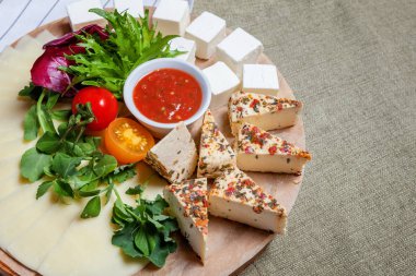 Farklı türde peyniri beyaz peynir-brynza, domates sos ve taze sebze ile yönetim kurulu. Restoran menü plaka