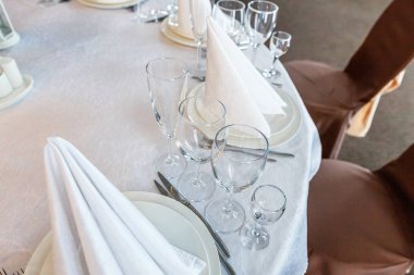 Gözlük, bir piramit katlanmış peçete akşam yemeği için restoran rahat iç görev yaptı. Düğün süslemeleri ve maddeler için gıda, beyaz masa örtüsü ile kaplı büyük bir tabloda catering hizmeti göre düzenlenmiş