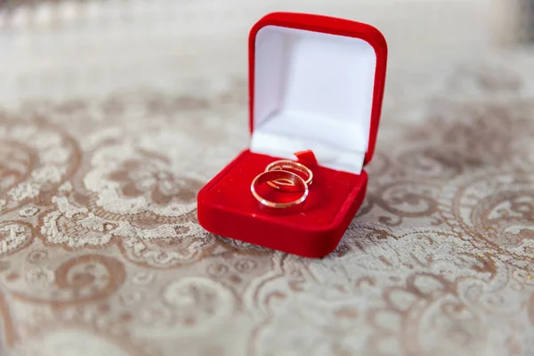 two golden wedding rings on a red box, wedding rings background concept