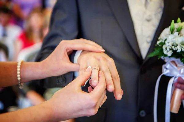 marriage hands with rings. birde wears the ring on the finger of the groom