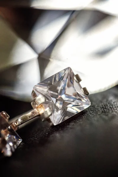 Diamond Stud Earrings with Reflection on a black background