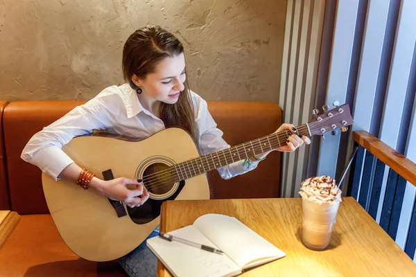 Jovem Sorrindo Hipster Mulher Sentada Tocando Guitarra Escrever Uma Música — Fotografia de Stock