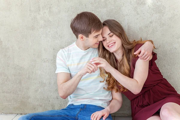 Young couple in love. Couple supporting each other and relying on each other having nice time together. Young happy woman hugging her handsome boyfriend. Portrait of cheerful casual people in love, students having hopes, dreams, goals, bride and groo