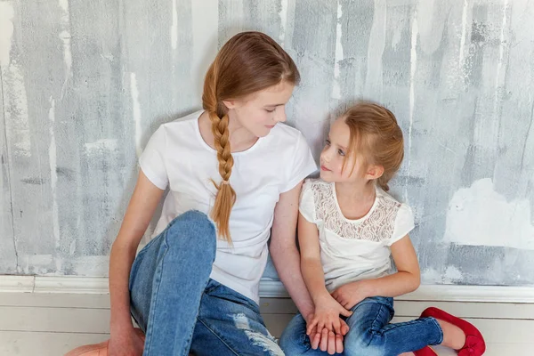 Two Happy Kids Sitting Grey Textured Wall Background Embracing Adorable — Stock Photo, Image