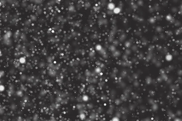Falling down real white snowflakes on black background. Isolated snowfall calm snow minimalistic design element. Snowstorm texture. Bokeh lights on black background, shot of flying snowflakes in air