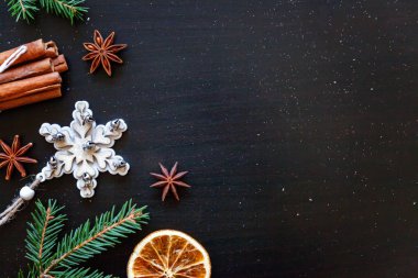 Yılbaşı yeni yıl kompozisyon kış nesneleri köknar dalı, baubles, tarçın, topu koyu siyah arka plan üzerine. Yat, görünümü, kopya alanı top. Noel Aralık zaman kutlama konsepti için