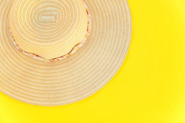 Flat Lay with striped retro hat on yellow colourful trendy modern fashion background. Vacation travel summer weekend sea adventure trip concept