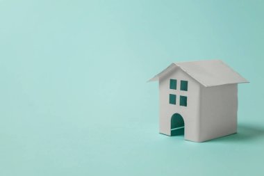 Sadece tasarım mavi pastel renkli şık arka plan üzerinde izole bir minyatür beyaz oyuncak ev. Mortgage Emlak sigorta rüya ev concept. Kopya alanı
