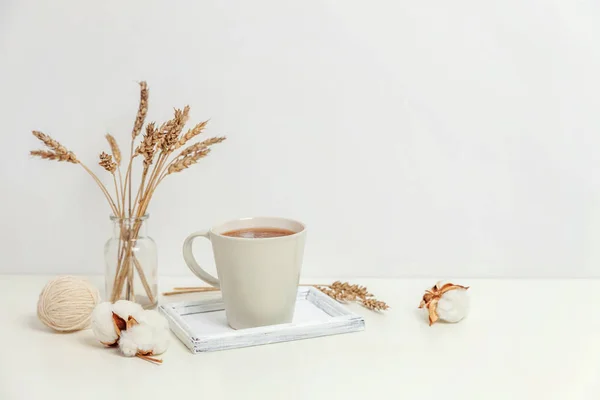 Natural eco home decor with cup coffee candle on wooden tray. Early morning breakfast lifestyle background. Interior decoration with hot drink mug. Hygge scandinavian style concept copy space