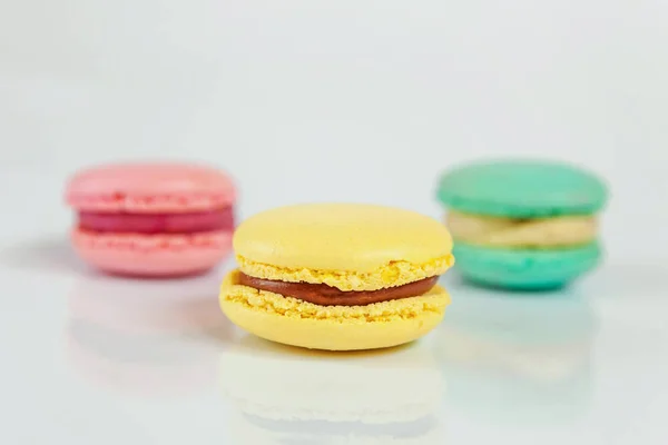 Sweet almond colorful pink, blue, yellow macaron or macaroon dessert cake isolated on white background. French sweet cookie. Minimal food bakery concept. Copy space