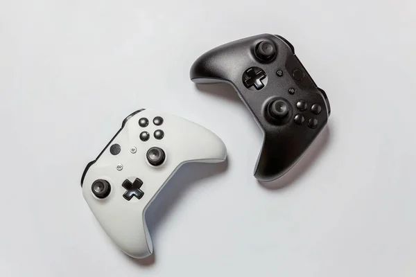 Beyaz ve siyah iki joystick gamepad, beyaz arka plan üzerinde izole oyun konsolu.