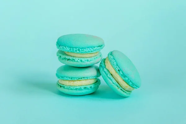 Sweet almond colorful unicorn blue macaron or macaroon dessert cake isolated on trendy blue pastel background. French sweet cookie. Minimal food bakery concept. Copy space