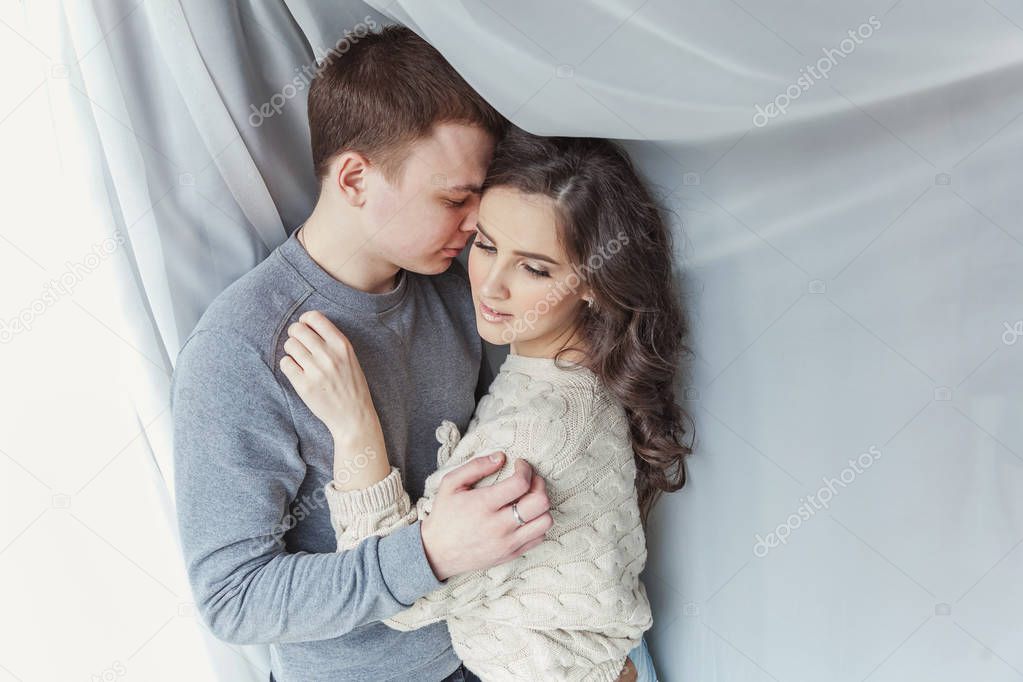 Romantic sexy couple in love having nice time together. Young woman hugging boyfriend, white background. Students, bride, groom, engagement, relationship, aspirations, supporting relying concept