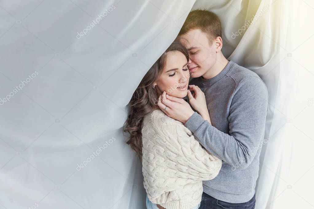 Romantic sexy couple in love having nice time together. Young woman hugging boyfriend, white background. Students, bride, groom, engagement, relationship, aspirations, supporting relying concept