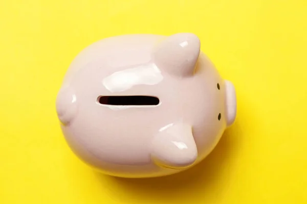 Saving investment budget wealth retirement financial money banking concept. Pink piggy bank isolated on yellow colourful trendy modern fashion background. Flat lay top view copy space