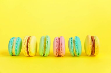 Tatlı badem renkli tek boynuzlu at pembe, mavi, yeşil badem kurabiyesi ya da modern moda arka planında izole edilmiş kurabiyeli pasta. Fransız kurabiyesi. Asgari gıda fırını konsepti. Boşluğu kopyala