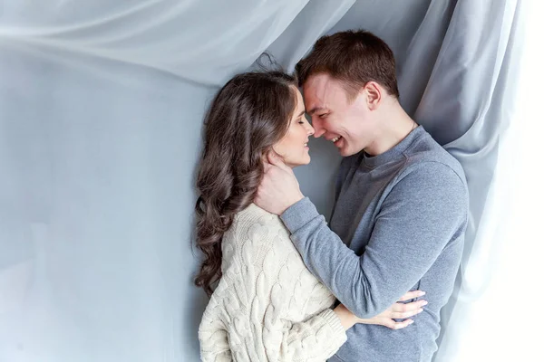 Romantic sexy couple in love having nice time together. Young woman hugging boyfriend, white background — Stock Photo, Image