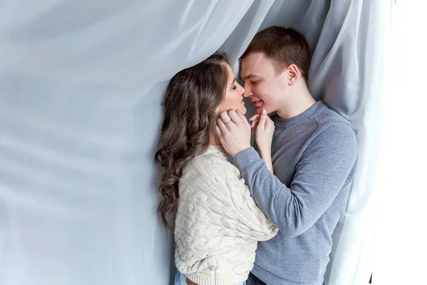 Romantic sexy couple in love having nice time together. Young woman hugging boyfriend, white background — Stock Photo, Image