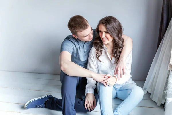 Romantic sexy couple in love having nice time together. Young woman hugging boyfriend, white background — Stock Photo, Image
