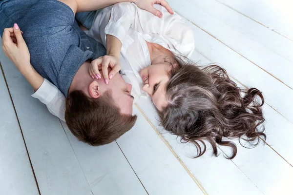 Romantic sexy couple in love having nice time together. Young woman hugging boyfriend, white background — Stock Photo, Image