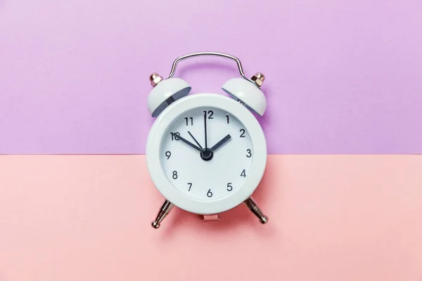 Vintage alarm clock Isolated on purple pink pastel background — Stock Photo, Image