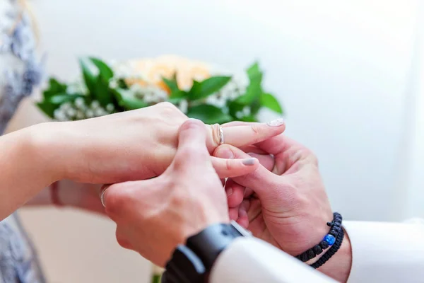 Novio mano poniendo anillo de boda en dedo de novia — Foto de Stock